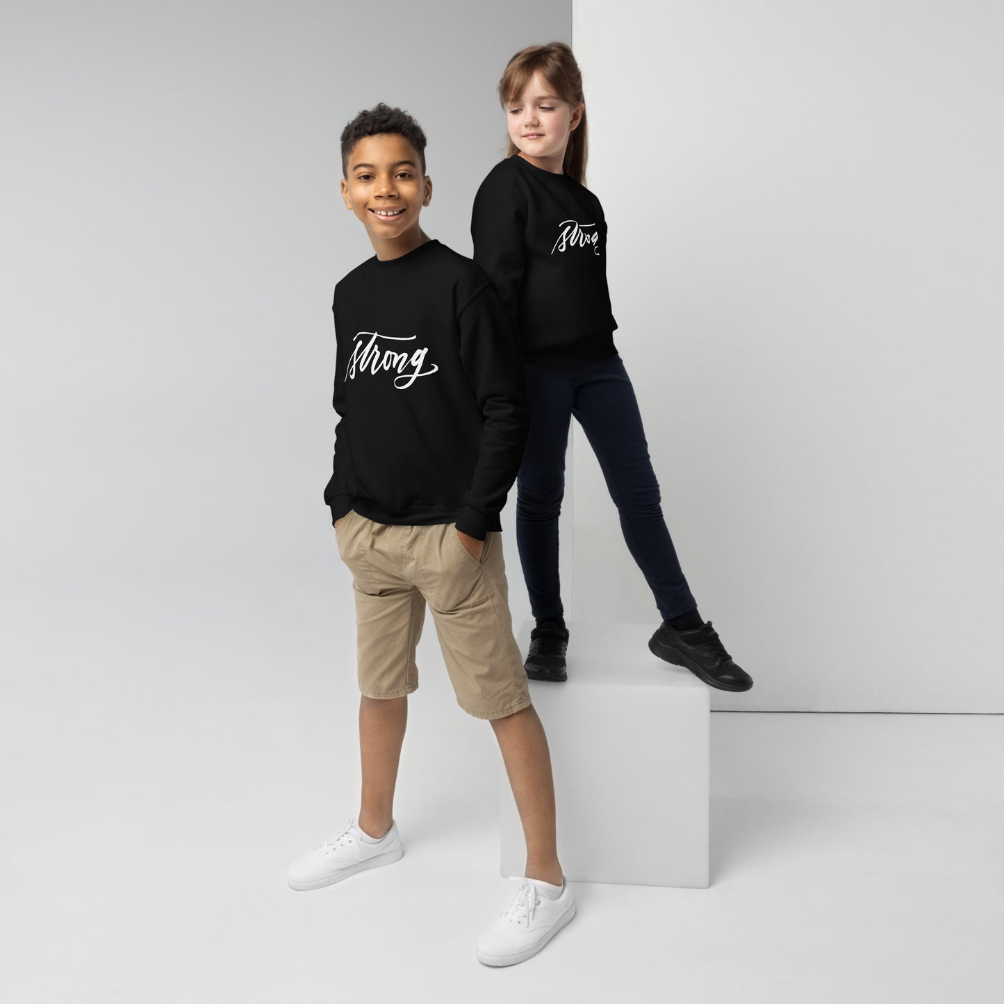 White Script "Strong" Calligraphy Printed on Kids' Crewneck Sweatshirt (Youth Sizes)