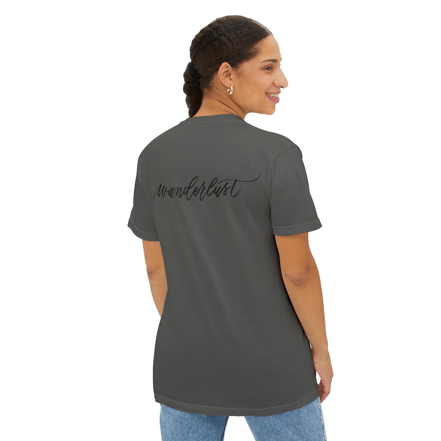 Woman turning to the side wearing a grey colored wanderlust t-shirt, perfect for traveling and airplane flights.