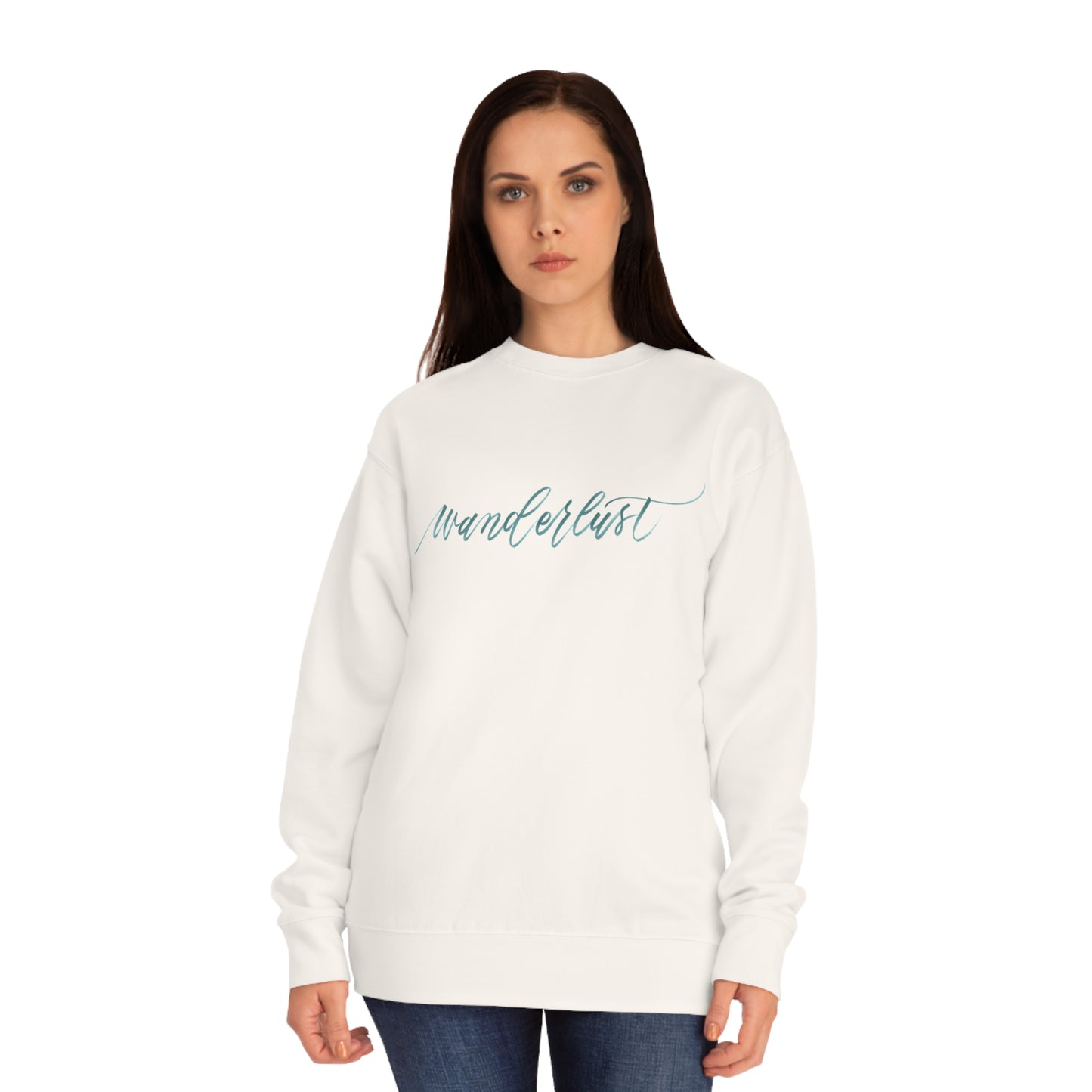 Woman wearing an ivory crewneck sweatshirt with a calligraphy design on front that reads "wanderlust".