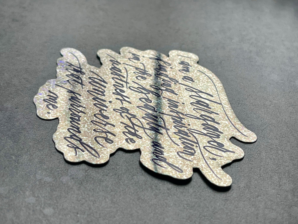 I am a stargazer finding inspiration in the beauty and vastness of the universe that surrounds me script calligraphy glitter sticker in shiny side view laid down to show sticker side view