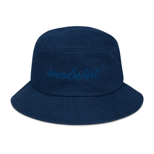 Denim blue bucket hat with modern calligraphy "wanderlust" word embroidered on with blue thread.